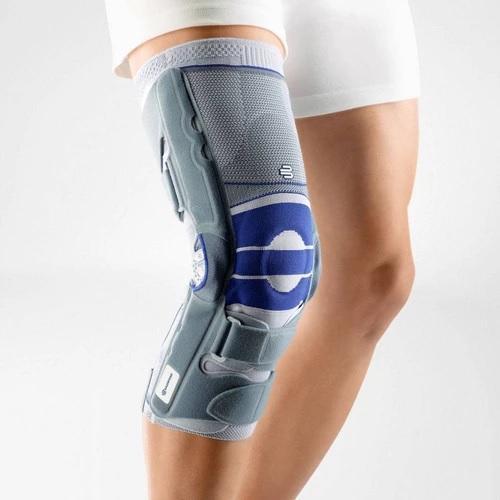 Knee brace in a colour combination of blue and grey and is worn on the right knee. It is considered one of Bauerfeind Australia's best recovery knee braces, Softec Genu.